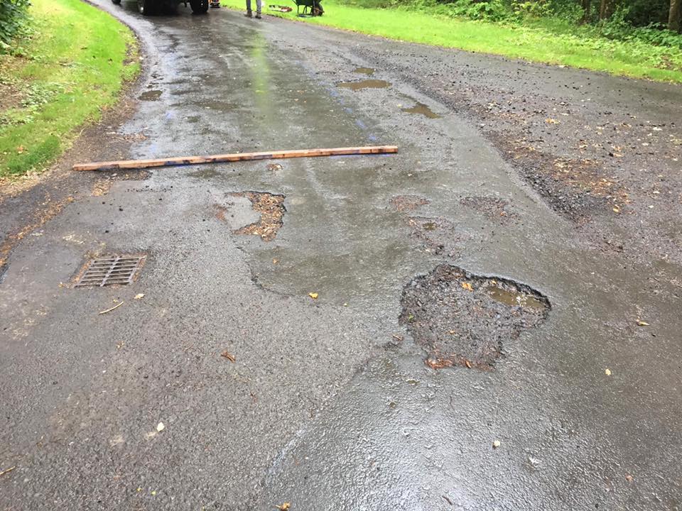 Resurfacing pot hole road repair works