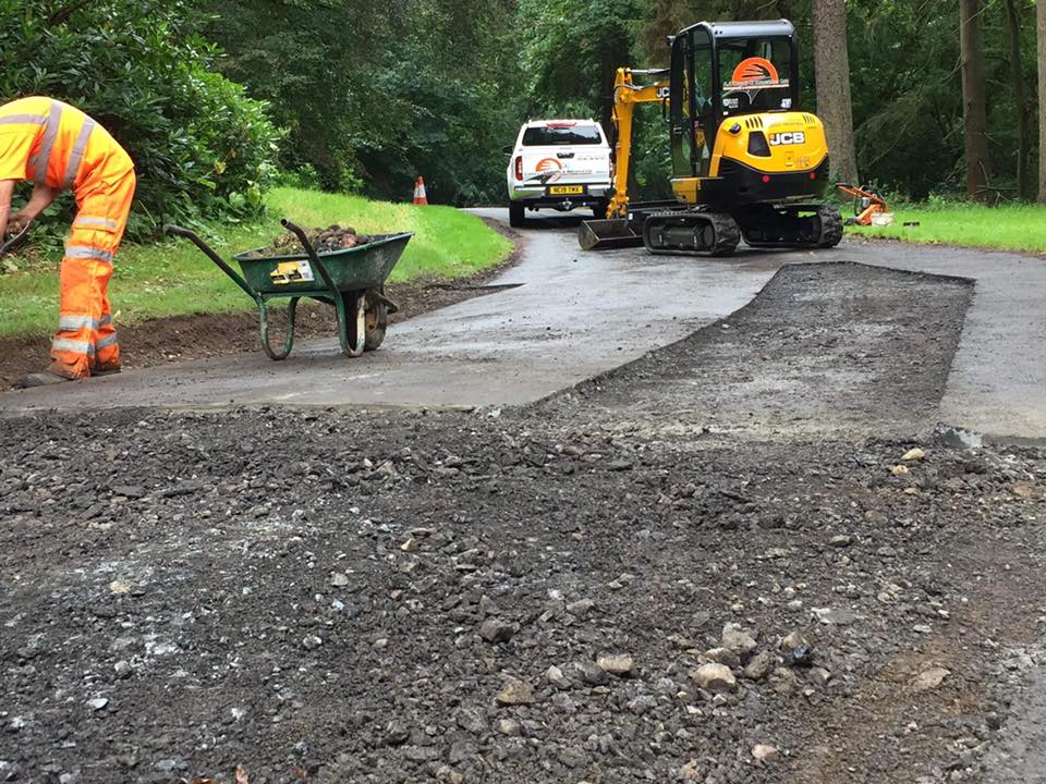 Resurfacing pot hole road repair works