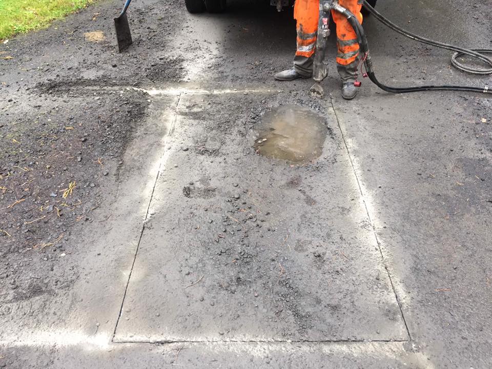 Resurfacing pot hole road repair works