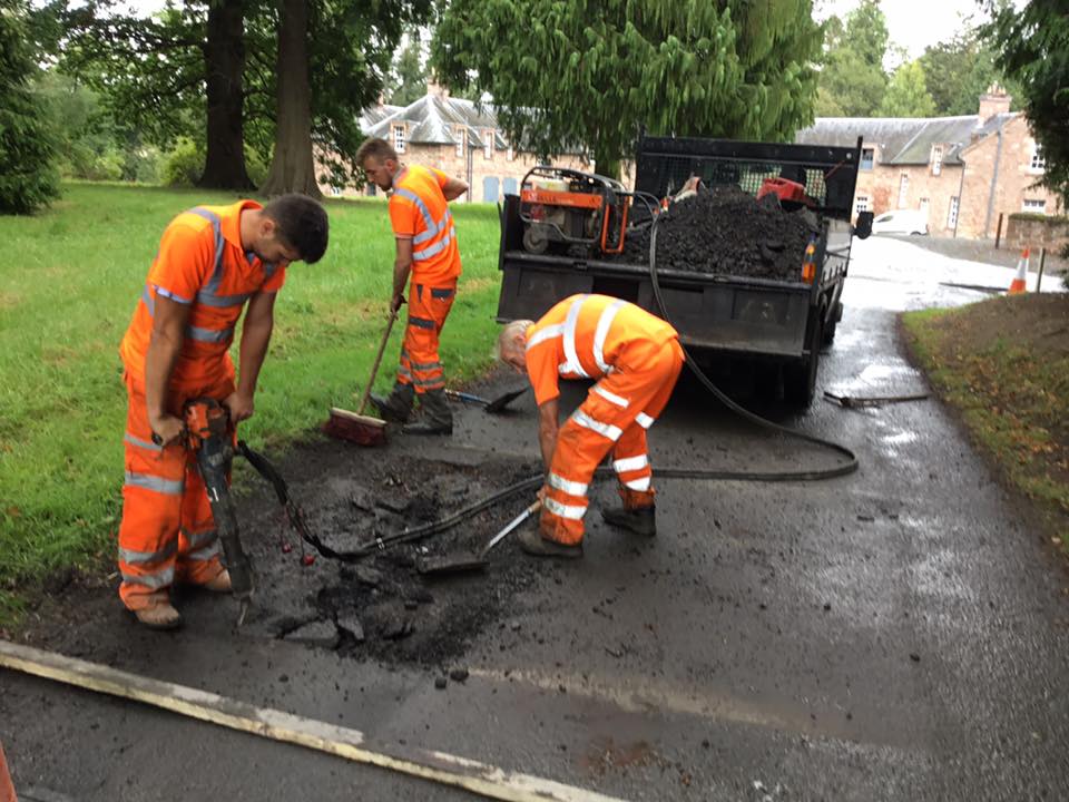 Resurfacing pot hole road repair works